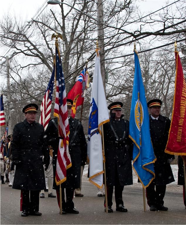 Military color guard forming on Main Street